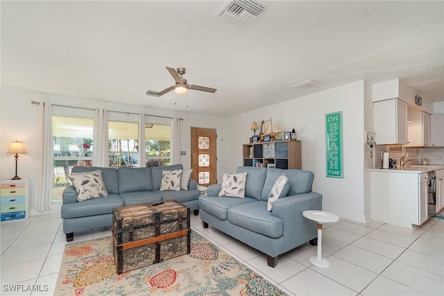 tiled living room featuring sink and ceiling fan