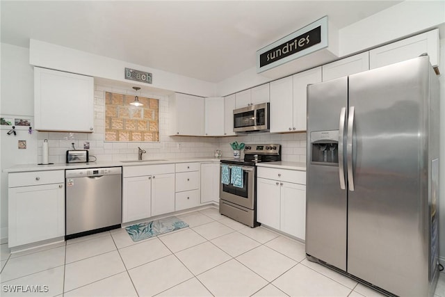 kitchen with white cabinets and appliances with stainless steel finishes