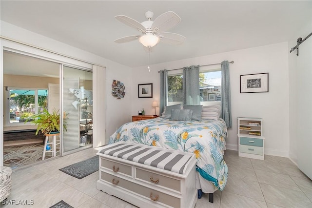 tiled bedroom with ceiling fan and a barn door