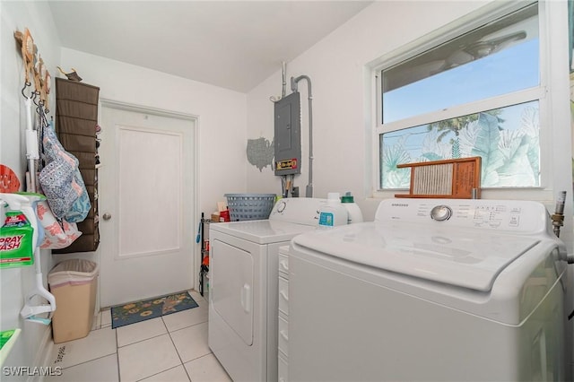 laundry room with separate washer and dryer, light tile patterned floors, and electric panel