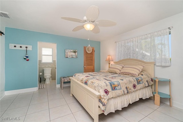 tiled bedroom with ceiling fan and ensuite bathroom