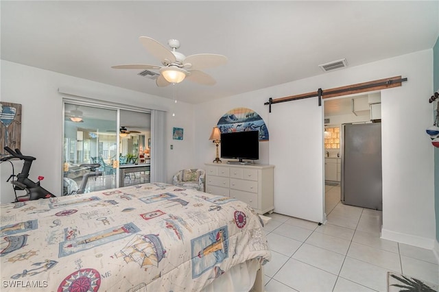 tiled bedroom with stainless steel fridge, ceiling fan, a barn door, and access to exterior