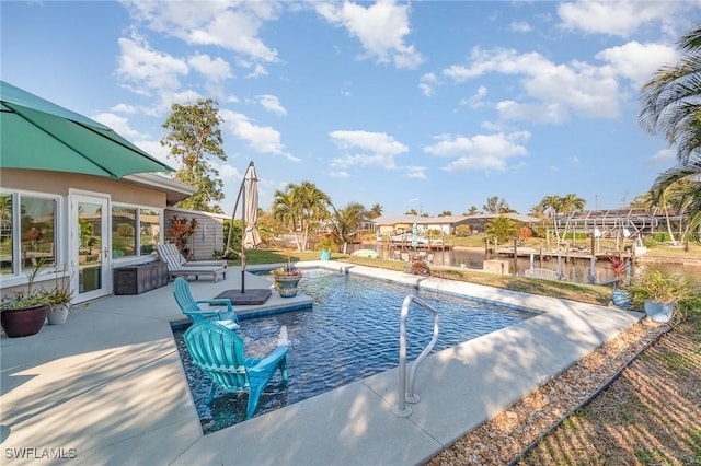 view of swimming pool with a patio and a water view