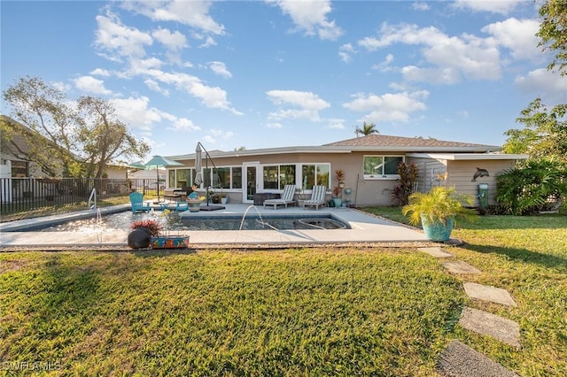 back of house with a patio and a yard