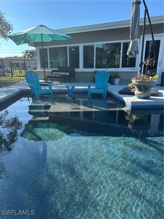 view of swimming pool featuring a sunroom