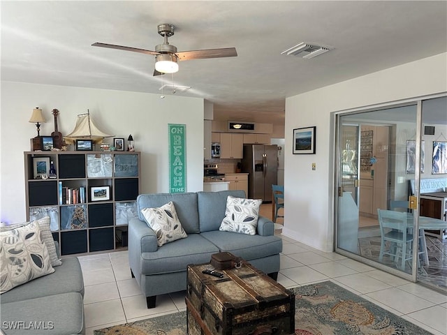 living room featuring light tile patterned flooring and ceiling fan