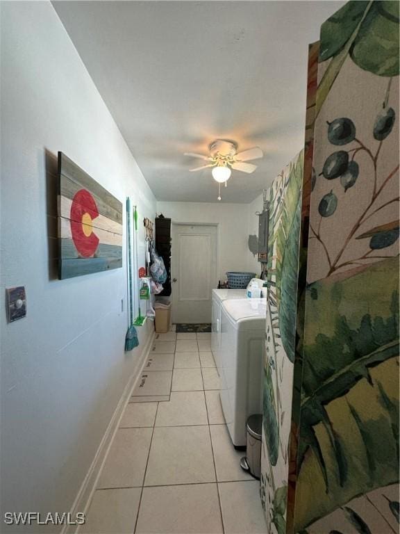 laundry room with separate washer and dryer, light tile patterned floors, and ceiling fan