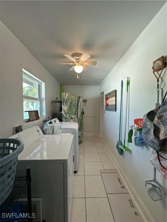 clothes washing area with independent washer and dryer, ceiling fan, and light tile patterned flooring