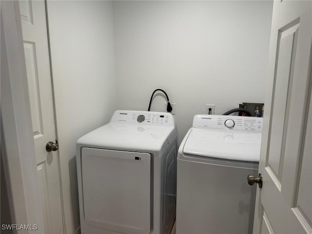 clothes washing area with washing machine and clothes dryer