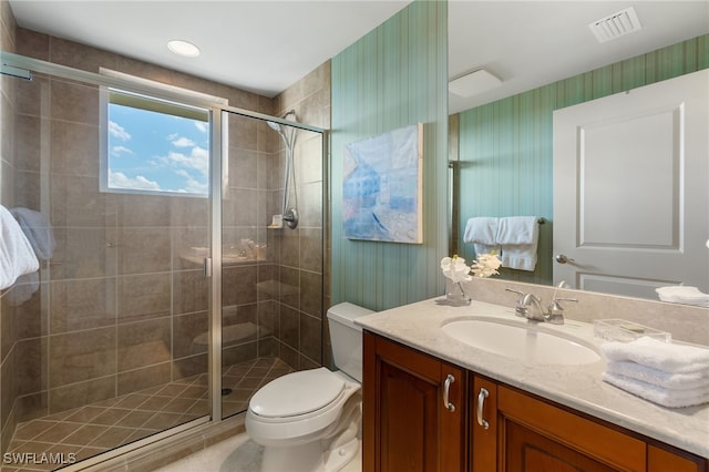 bathroom with walk in shower, vanity, and toilet