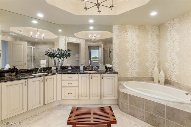 bathroom featuring crown molding, separate shower and tub, vanity, a tray ceiling, and a notable chandelier