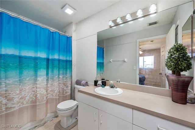 bathroom with ceiling fan, vanity, toilet, and tile patterned floors