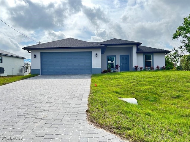 view of front of property featuring a garage and a front yard