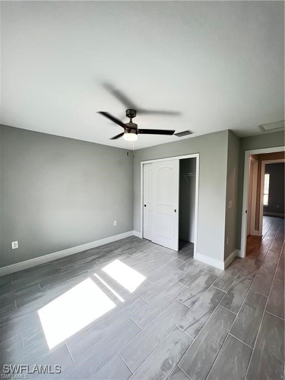 unfurnished bedroom featuring a closet and ceiling fan