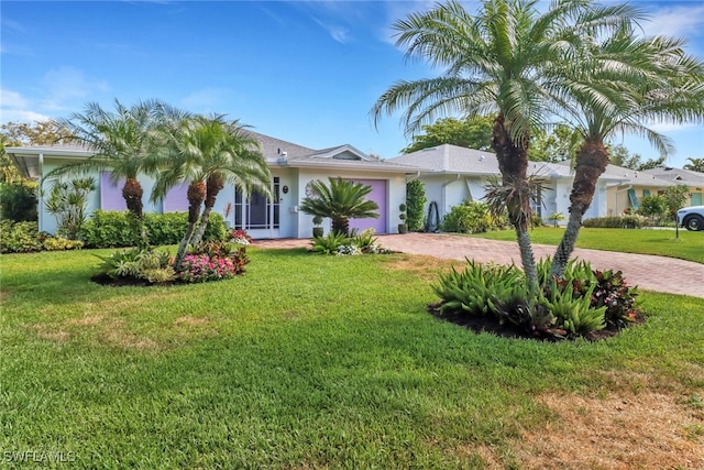 view of front of property with a garage and a front yard