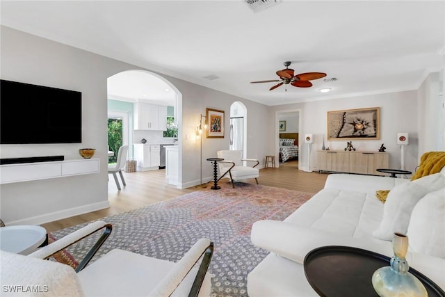 living room featuring ceiling fan and light hardwood / wood-style flooring