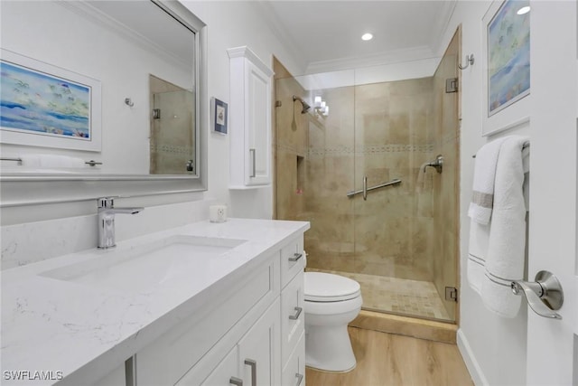 bathroom featuring walk in shower, toilet, ornamental molding, vanity, and hardwood / wood-style floors