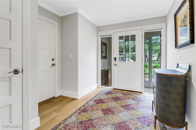 foyer featuring crown molding and light wood-type flooring