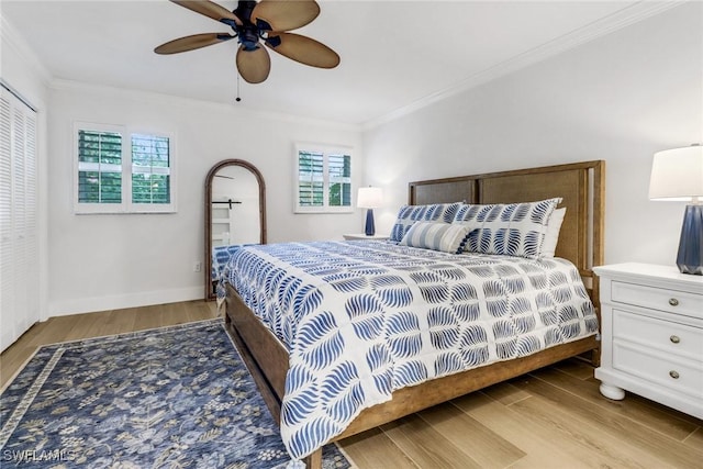 bedroom featuring ornamental molding, ceiling fan, and light wood-type flooring