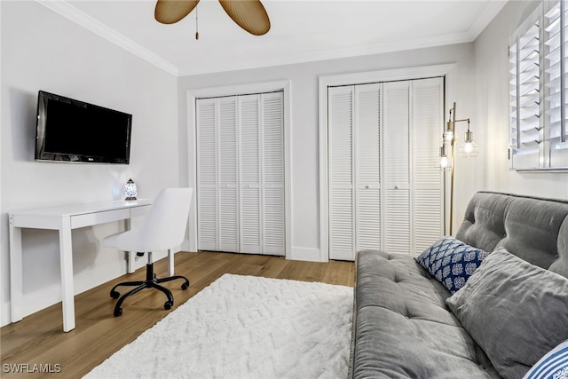 office with crown molding, wood-type flooring, and ceiling fan