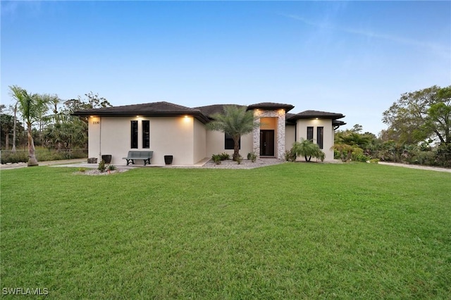 prairie-style house with a front lawn