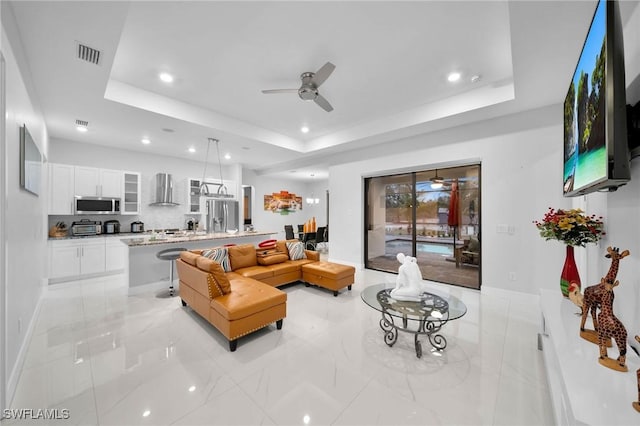2330 6th Ave NE, Naples, FL 34120 - living room featuring a raised ceiling and ceiling fan