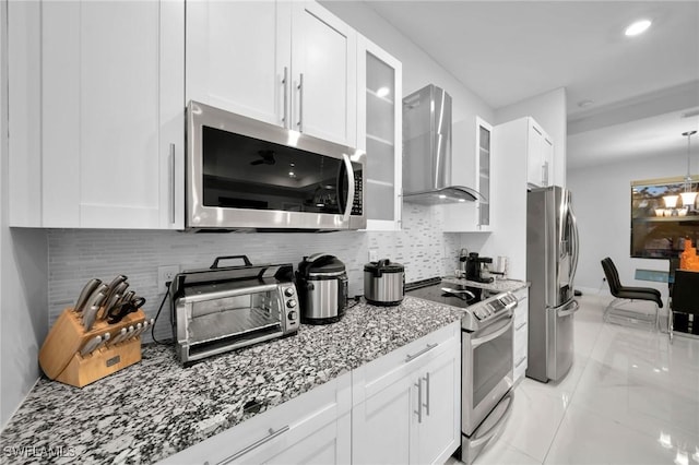 2330 6th Ave NE, Naples, FL 34120 - kitchen featuring stainless steel appliances, white cabinets, and wall chimney exhaust hood