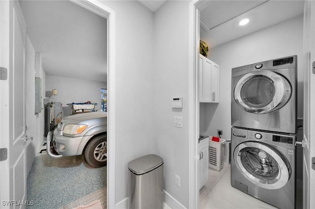 2330 6th Ave NE, Naples, FL 34120 - clothes washing area featuring cabinets and stacked washer and clothes dryer
