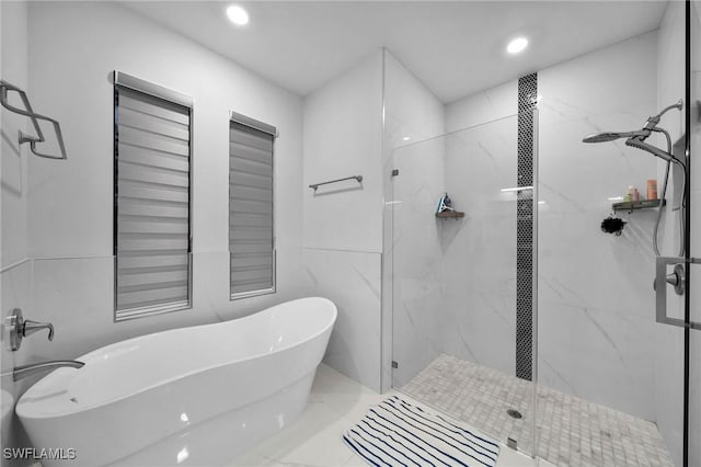 2330 6th Ave NE, Naples, FL 34120 - bathroom featuring tile walls and independent shower and bath