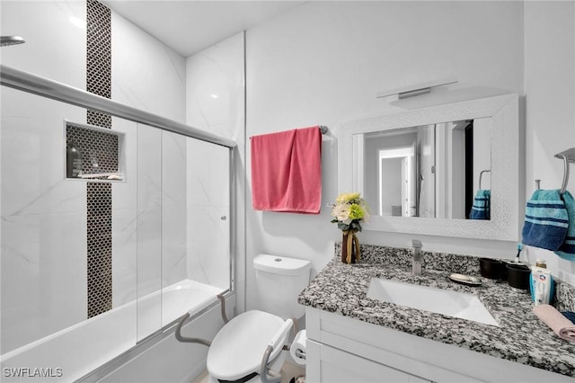 2330 6th Ave NE, Naples, FL 34120 - full bathroom featuring vanity, enclosed tub / shower combo, and toilet