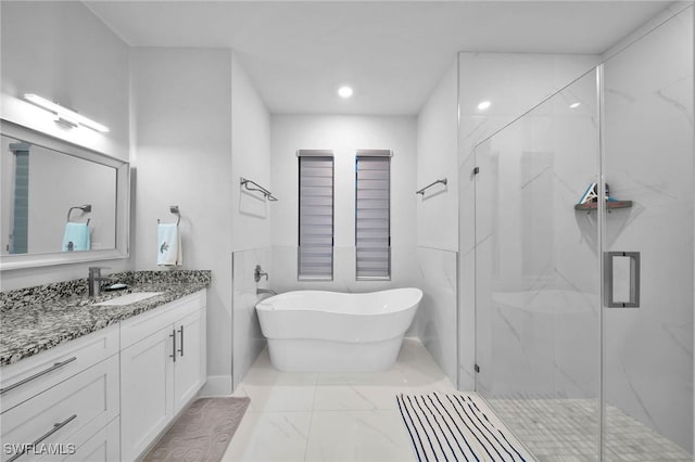 2330 6th Ave NE, Naples, FL 34120 - bathroom with vanity and shower with separate bathtub