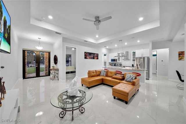 2330 6th Ave NE, Naples, FL 34120 - living room featuring a tray ceiling and ceiling fan