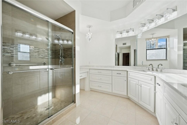 bathroom featuring walk in shower, vanity, and a chandelier