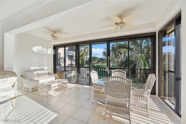 sunroom featuring ceiling fan