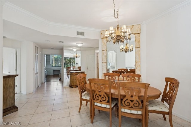 tiled dining space with crown molding and a chandelier