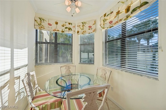 dining area with ornamental molding and ceiling fan