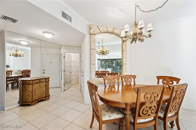 dining area with ornamental molding, light tile patterned floors, and a chandelier