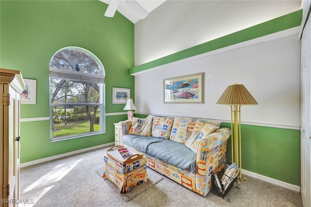 carpeted living room featuring high vaulted ceiling