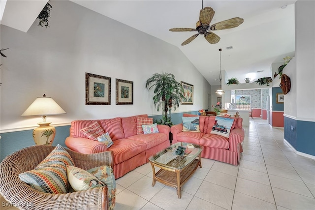 tiled living room with ceiling fan and vaulted ceiling