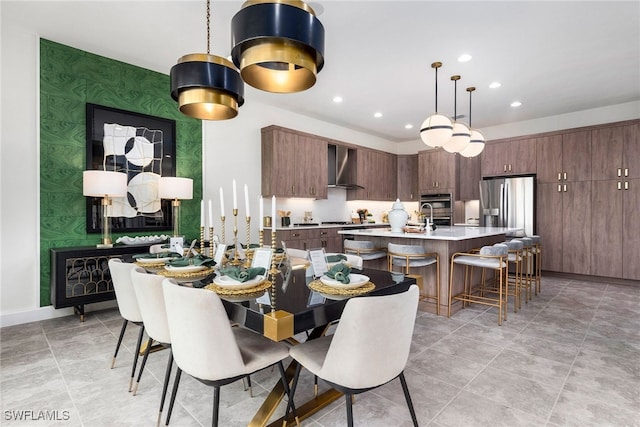 dining area with an accent wall, recessed lighting, baseboards, and wallpapered walls