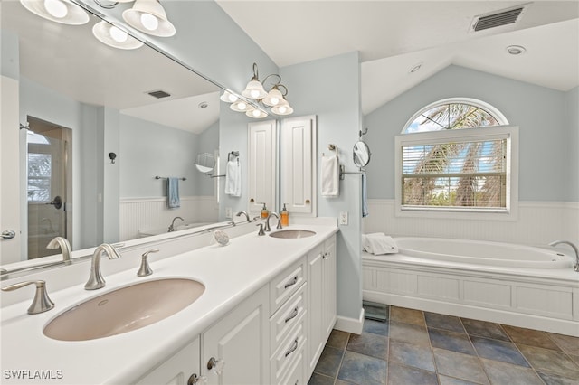 bathroom with vaulted ceiling, separate shower and tub, vanity, and a chandelier