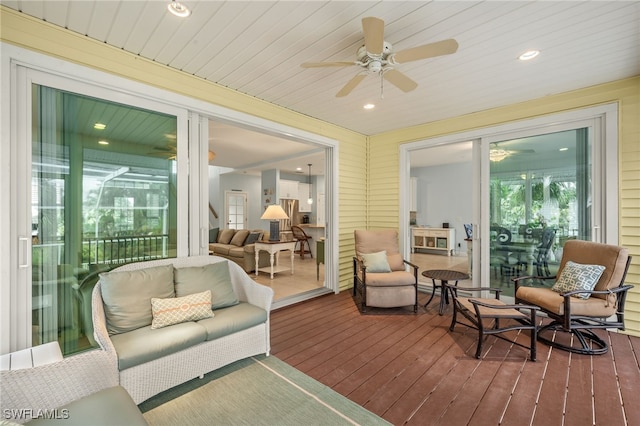 sunroom featuring ceiling fan