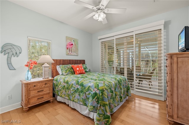 bedroom with multiple windows and light hardwood / wood-style flooring