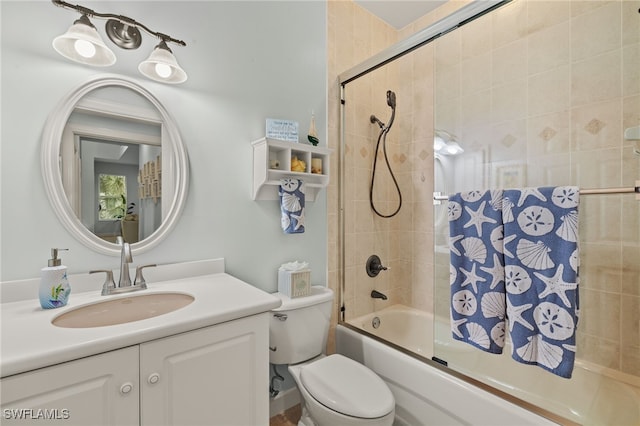 full bathroom with vanity, shower / bath combination with glass door, and toilet