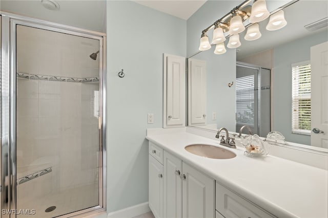 bathroom with walk in shower and vanity