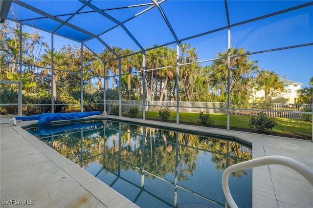 view of swimming pool with a patio and a lanai