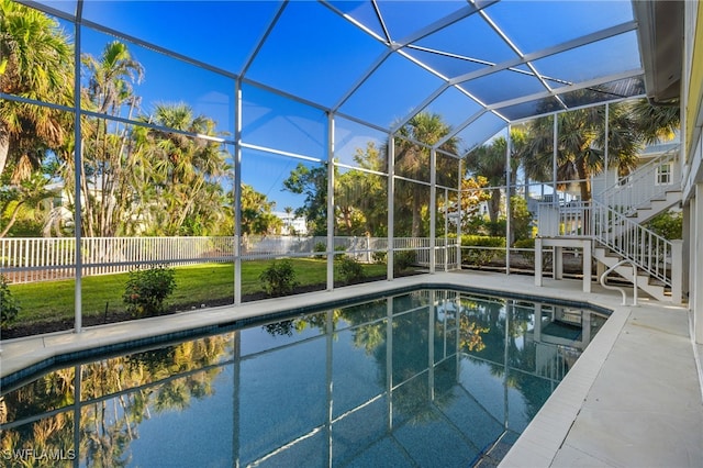 view of pool featuring a patio and glass enclosure