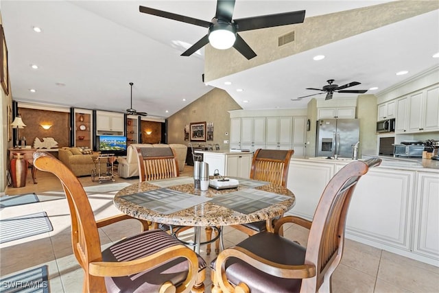 dining room with ceiling fan, recessed lighting, vaulted ceiling, and light tile patterned floors