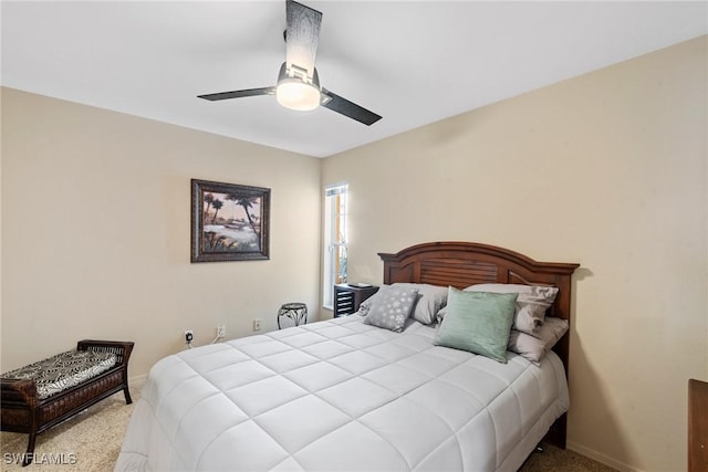 carpeted bedroom with a ceiling fan and baseboards