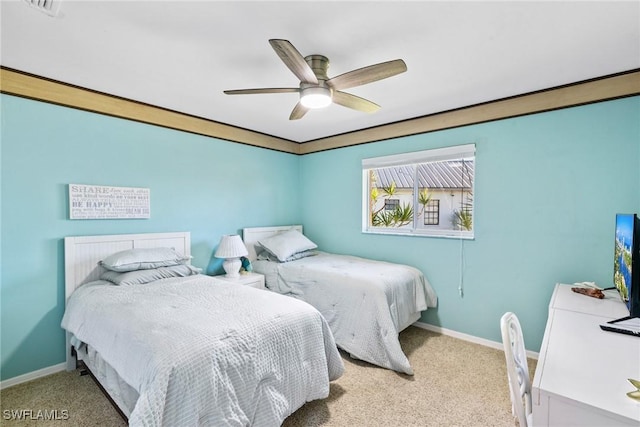 bedroom featuring light carpet, ceiling fan, crown molding, and baseboards